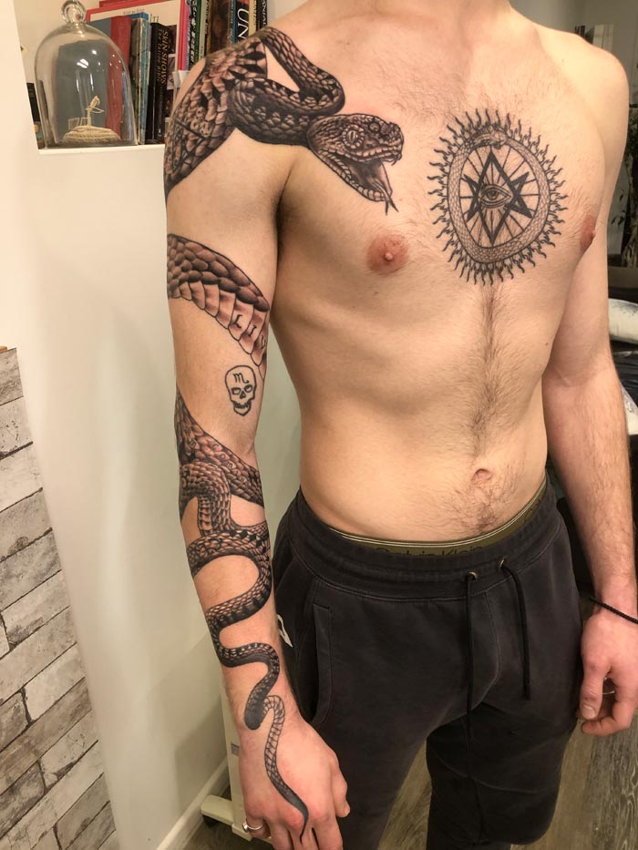 Snake wrapping around the arm and onto the chest