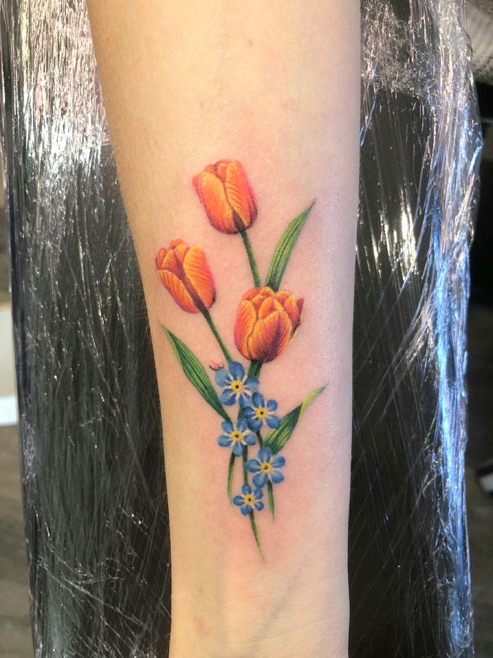 Forget me nots and tulips tattoo
