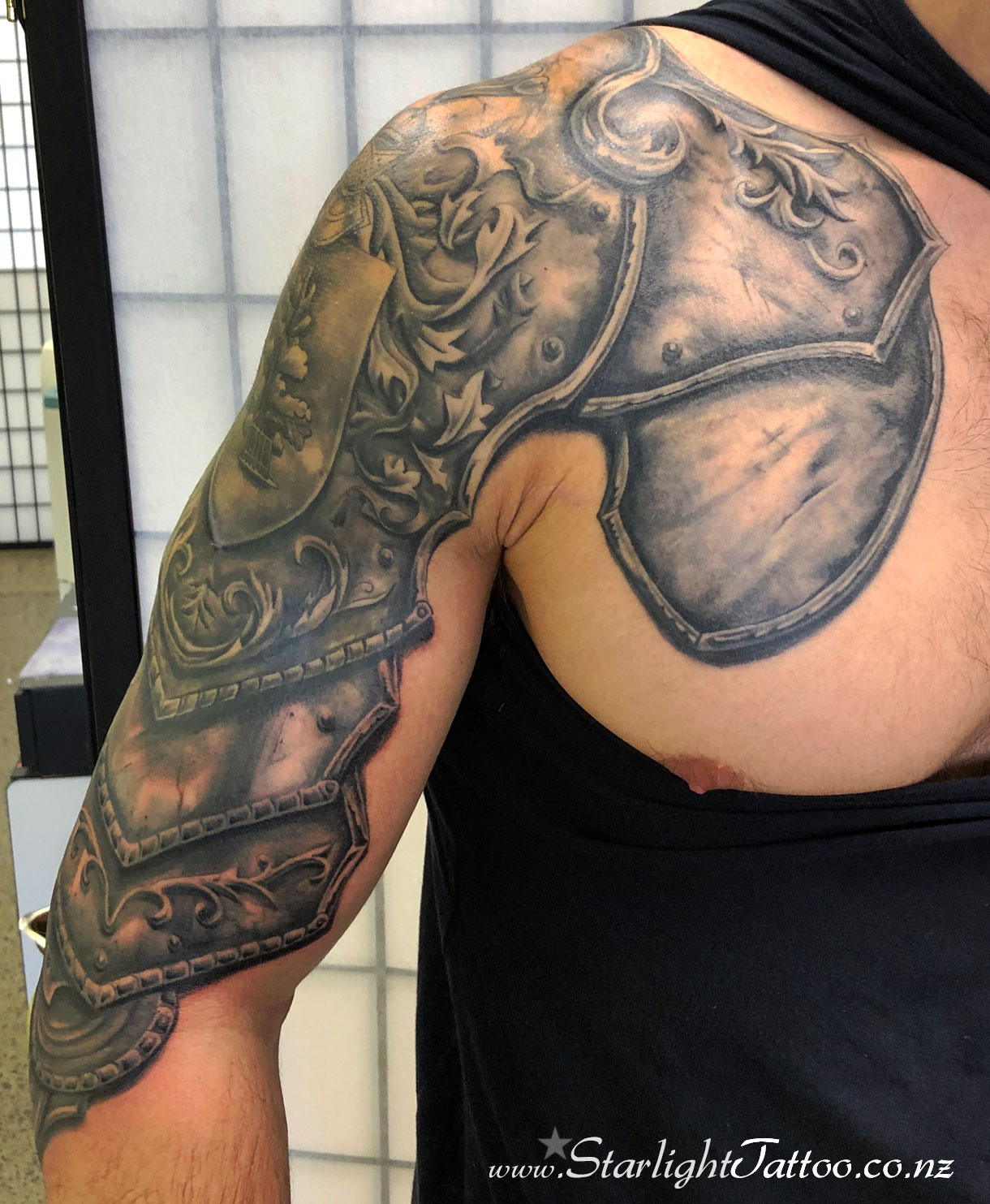 Realism blackwork armour shoulder piece - custom tattoo Auckland