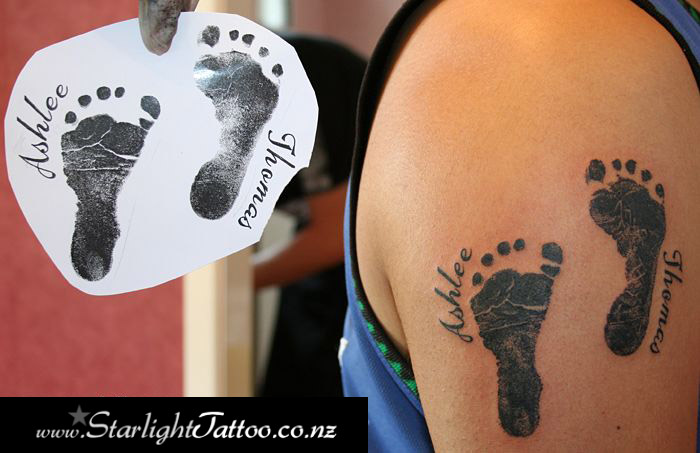 Children’s footprints tattoo - sentimental black and grey ink