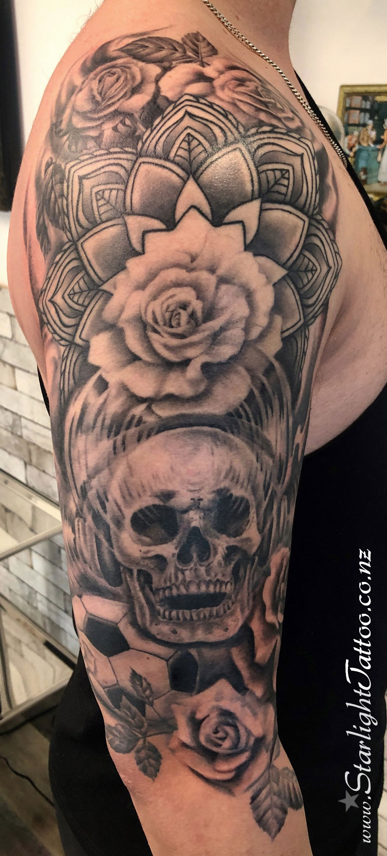 DJ-themed sleeve tattoo in black and grey realism