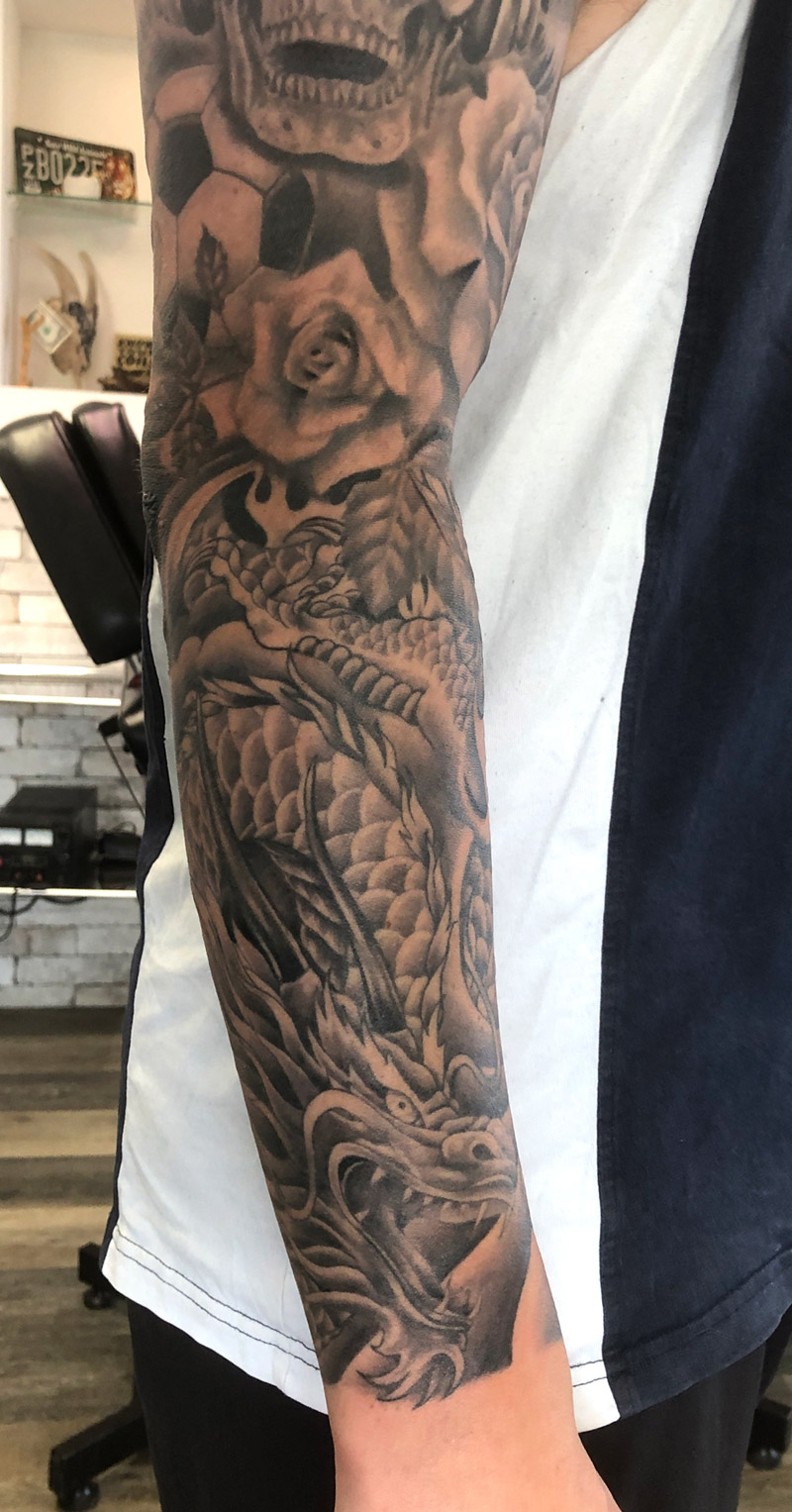 Dragon tattoo in black and grey - Auckland tattoo expert