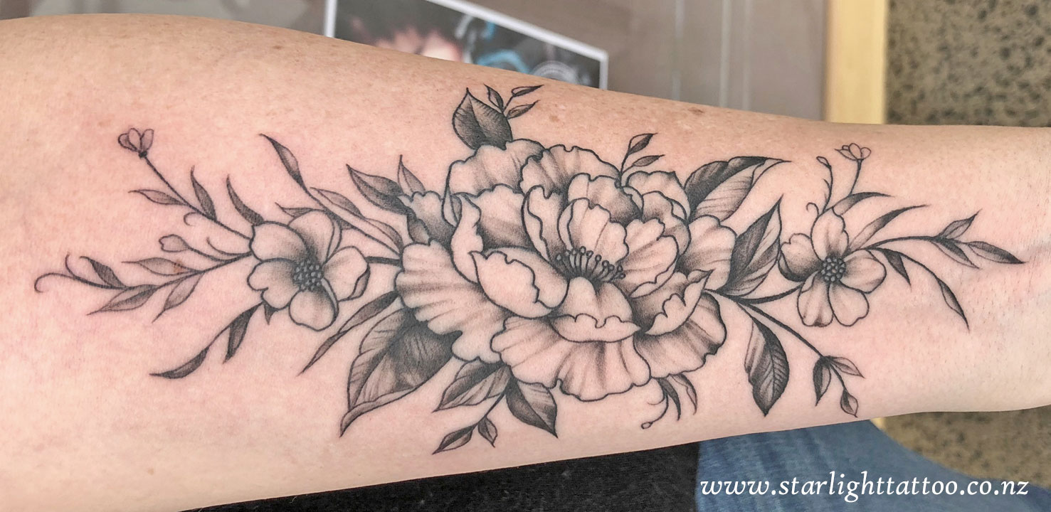 Black and grey floral tattoo - delicate botanical ink