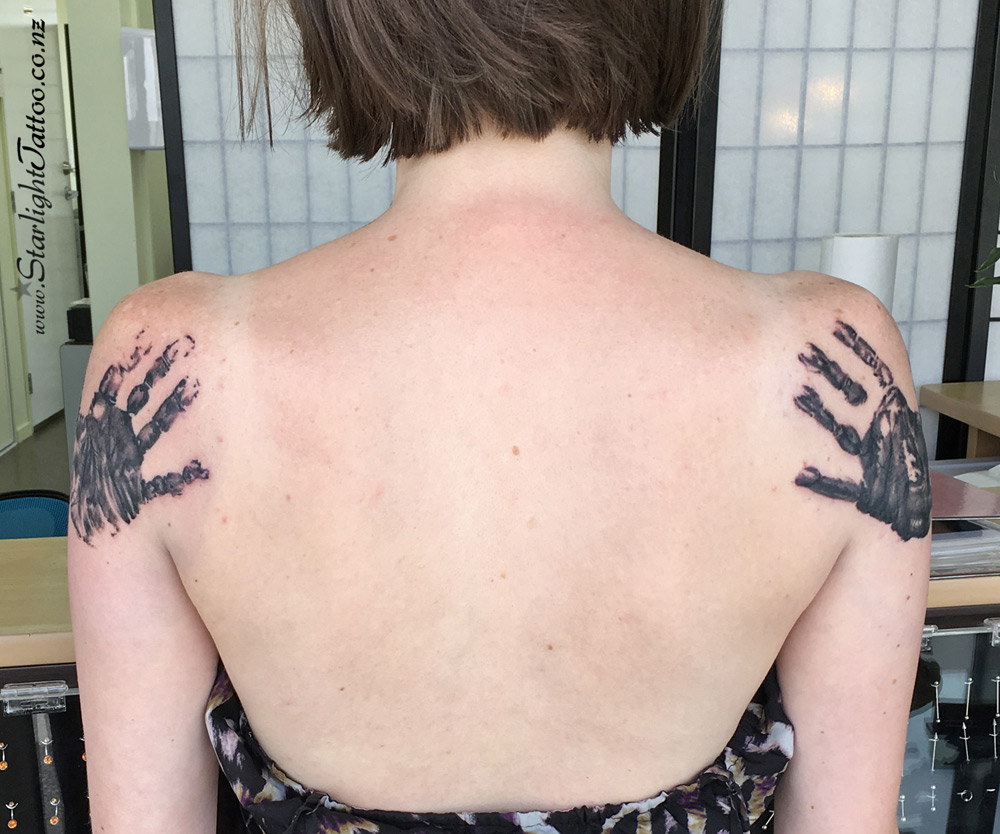 Tattoo of child hugging parent - emotional black and grey design