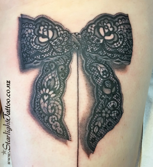 Lace bow tattoo - fine detail feminine black and grey ink
