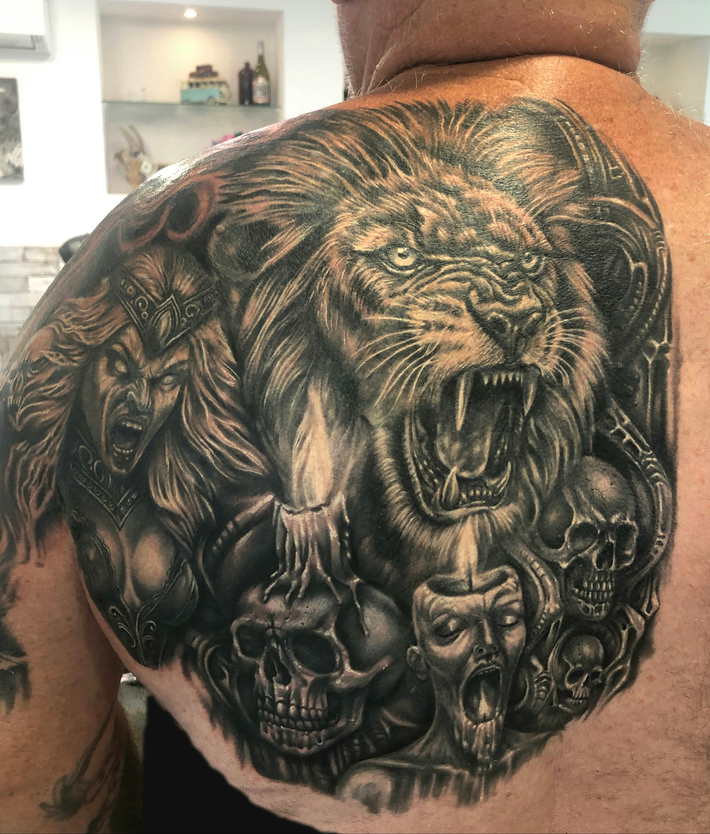 Lion and witch tattoo