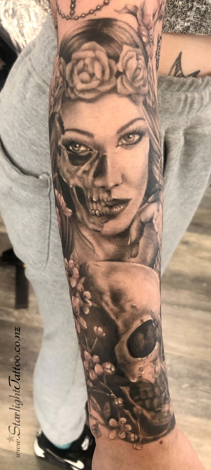 Woman’s face and skull tattoo - realism blend in black and grey