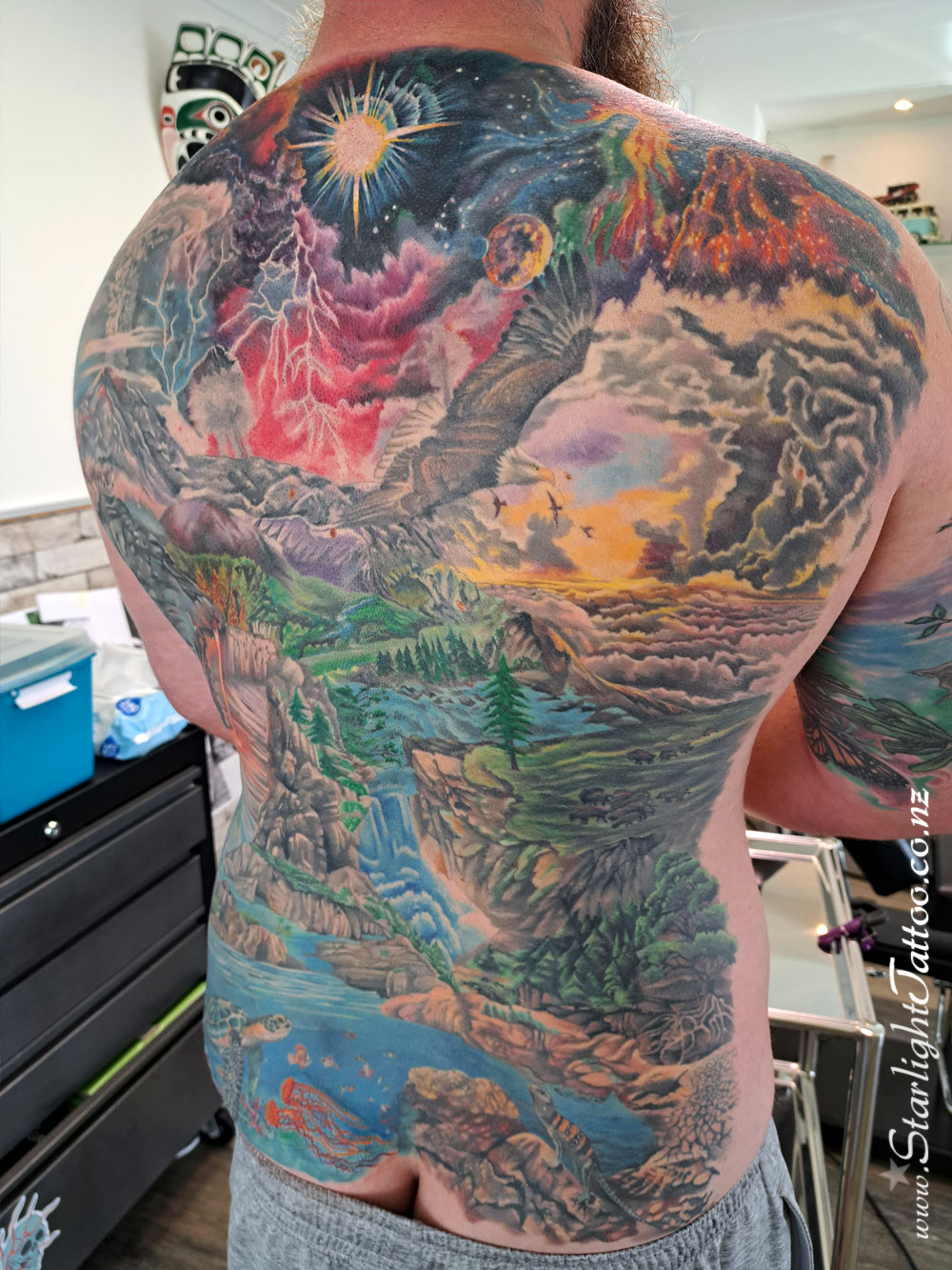 Intricate back piece in vibrant colour - custom large-scale tattoo art from Auckland