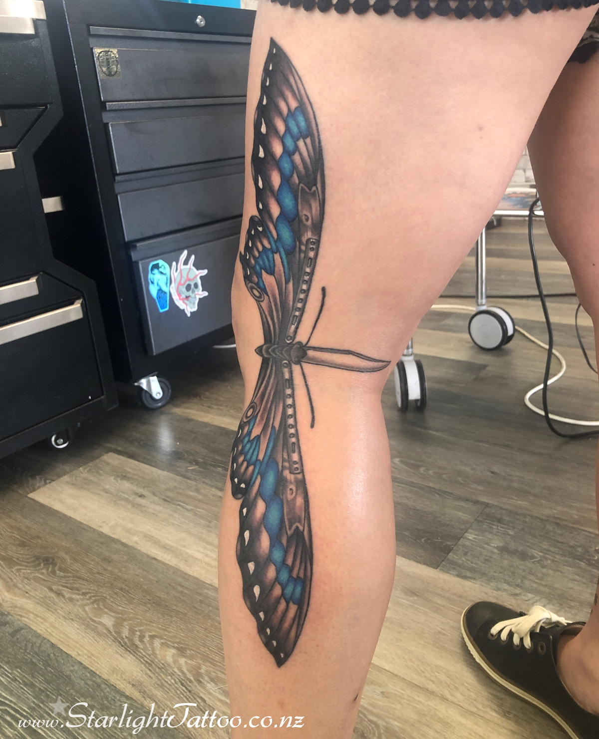 Blade and butterfly fusion tattoo in vivid contrasts