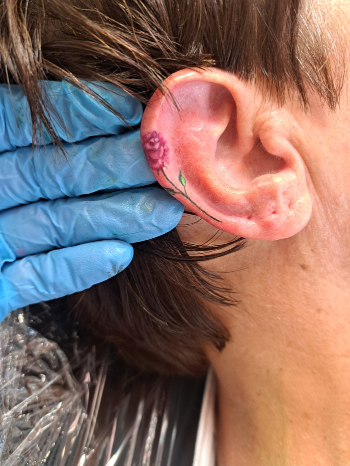 Minimalist ear tattoo in subtle tones - delicate inkwork by Auckland tattooist