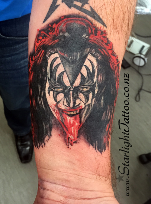 Gene Simmons portrait tattoo in theatrical fire tones - rock icon