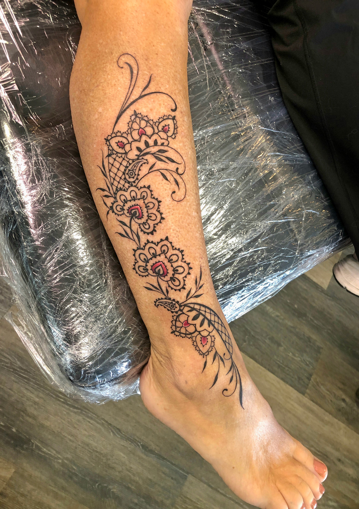Elegant ornamental floral leg tattoo
