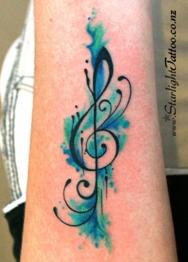 Musical treble clef with fluid watercolour tones - artistic music tattoo