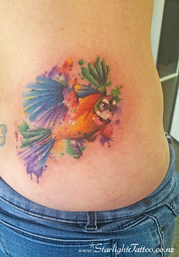 A colourful tattoo featuring watercolor fantail - unique tattoo composition