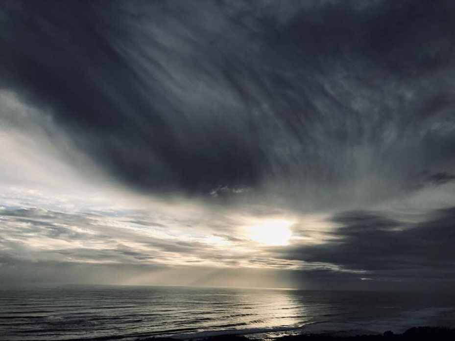 Storm clouds rolling over the ocean horizon at Muriwai