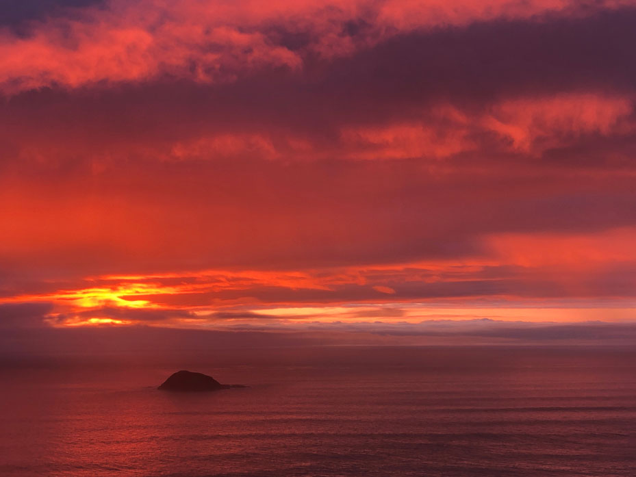 Fiery sunset over the ocean from Muriwai coastline
