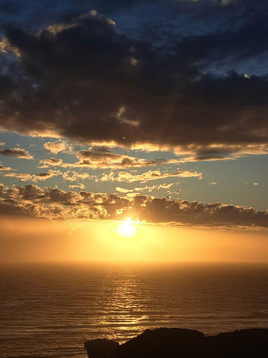 Brilliant sunset casting golden light across the shoreline
